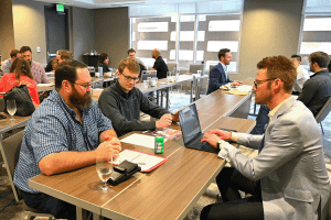 President Chris Balster working with Engineers Tim Copper and Teddy Klovstad during a group project during the 2024 Spring Summit.